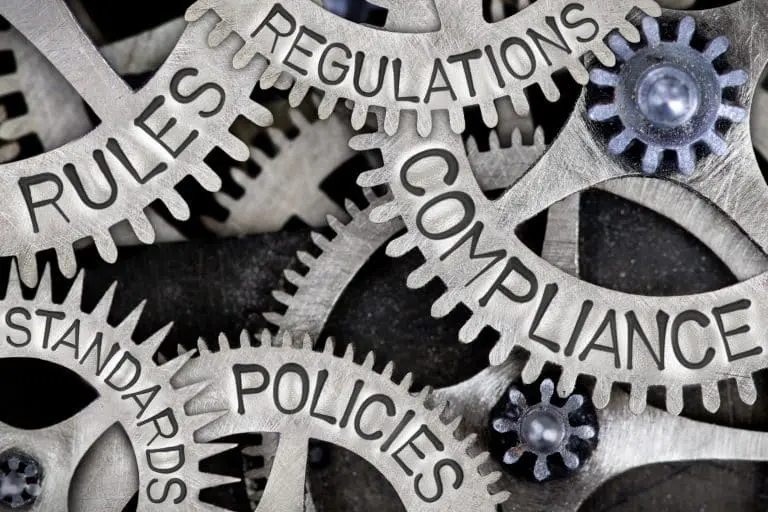 Interlocking gears illustrate compliance and professional standards.