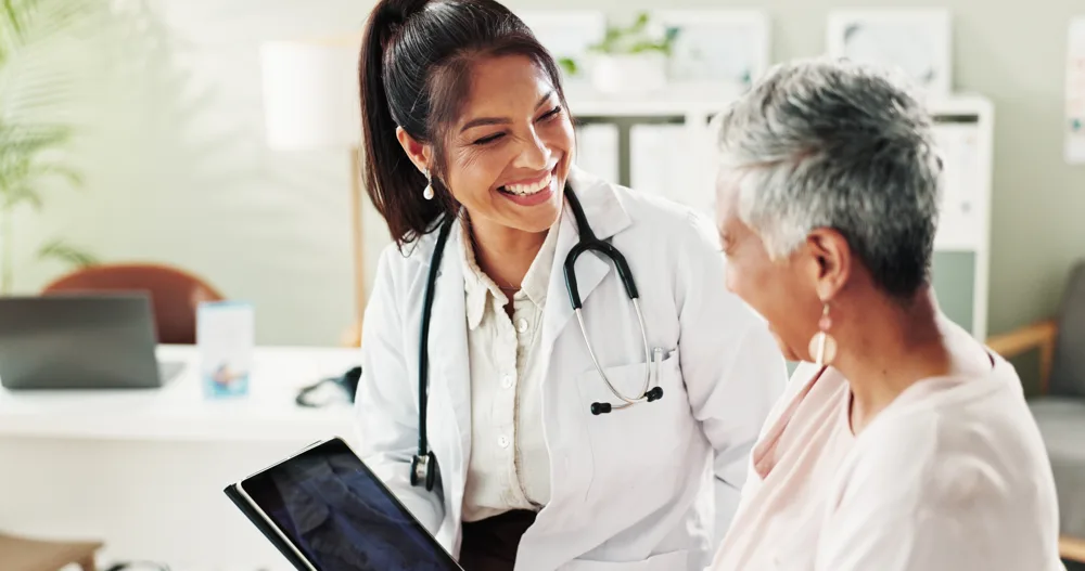 A clinician talking with a patient in a consultation room